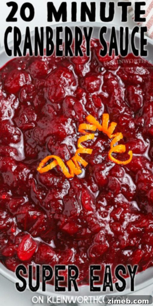 Effortless Cranberry Sauce 2 Easy Homemade Cranberry Sauce garnished with orange slices and cinnamon sticks, highlighting its vibrant color and rich texture.