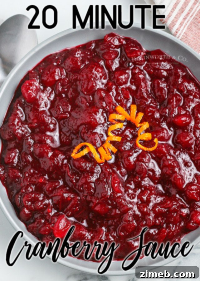 Effortless Cranberry Sauce 23 A vibrant and fresh Easy Homemade Cranberry Sauce in a serving bowl, garnished with whole cranberries and a sprig of rosemary.