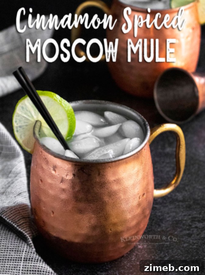 Cinnamon Ember Mule 17 Cinnamon Spiced Moscow Mule with festive garnishes, ready for holiday celebrations.