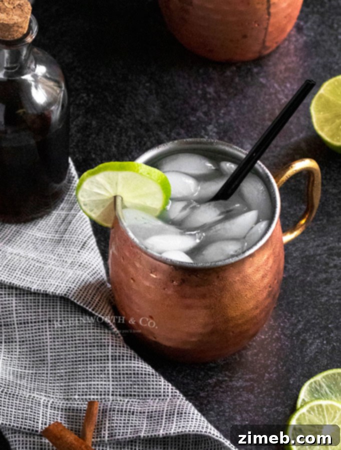 Cinnamon Ember Mule 4 Thanksgiving Mule, a vibrant cocktail featuring cinnamon, ginger beer, vodka, and lime, perfect for fall festivities.