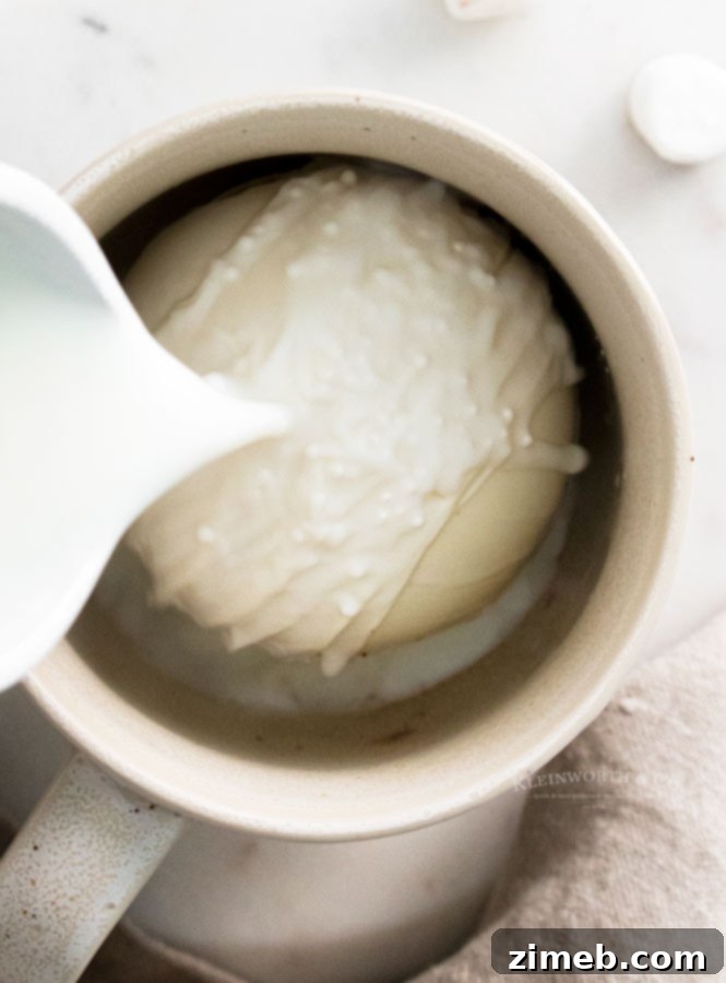 Mug-Melting Cocoa Surprises 22 Making White Chocolate Hot Cocoa Bombs by pouring hot milk