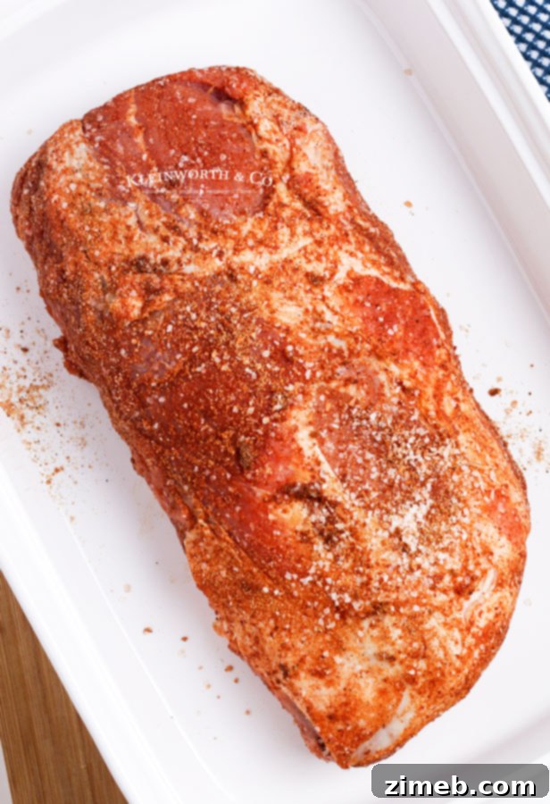 Succulent Pork Loin 7 A seasoned pork roast ready for the oven, showcasing the herb and spice rub.