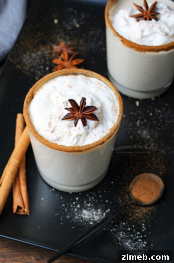 Timeless Homemade Eggnog 13 The best recipe for homemade eggnog, served in a festive glass with a cinnamon stick, demonstrating its smooth and inviting texture.