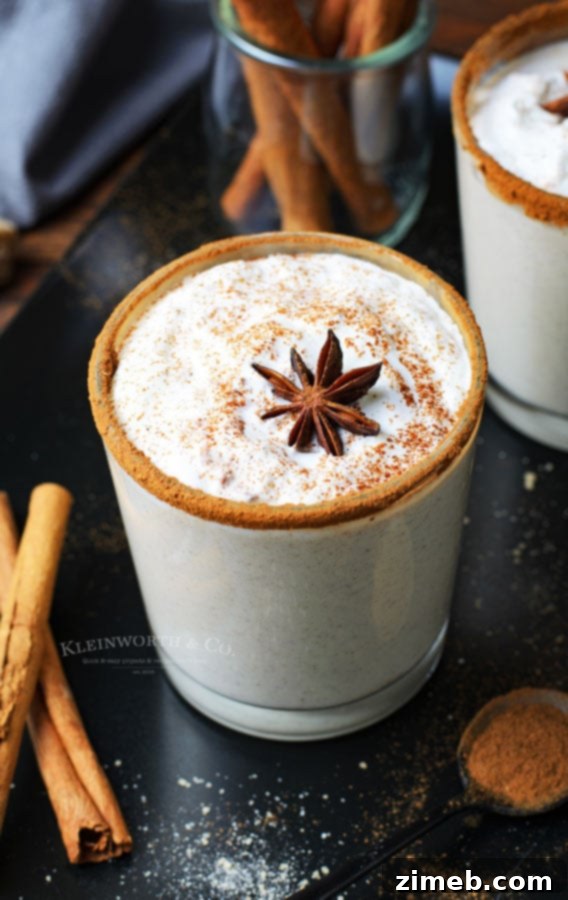 Timeless Homemade Eggnog 22 A festive glass of homemade eggnog, a perfect holiday drink for cozy moments and celebrations, topped with whipped cream and cinnamon.