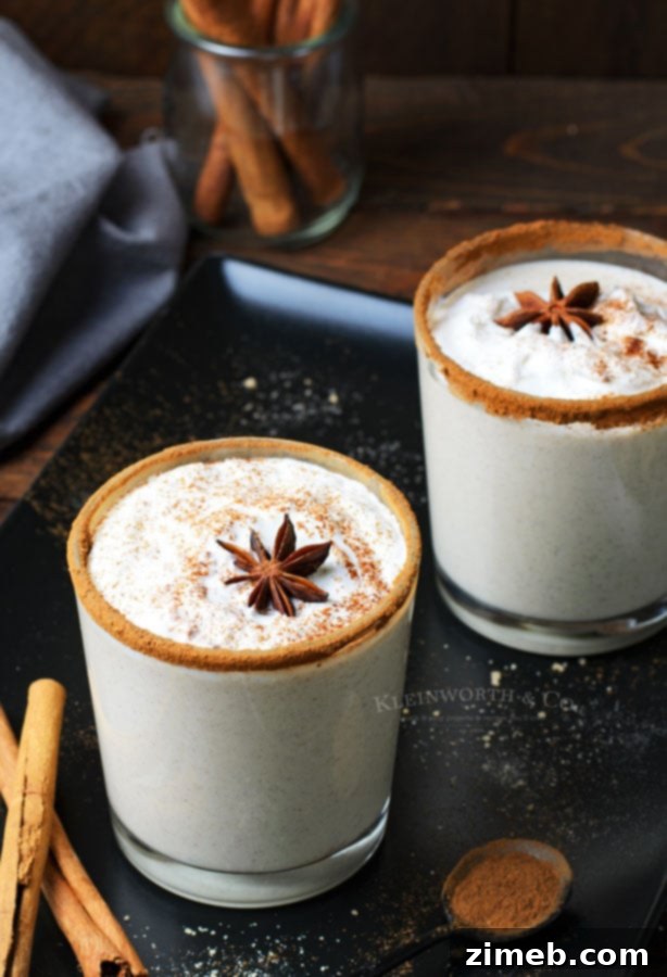 Timeless Homemade Eggnog 5 Homemade eggnog infused with the aromatic warmth of nutmeg and cinnamon, presented in an elegant glass, ready for holiday enjoyment.