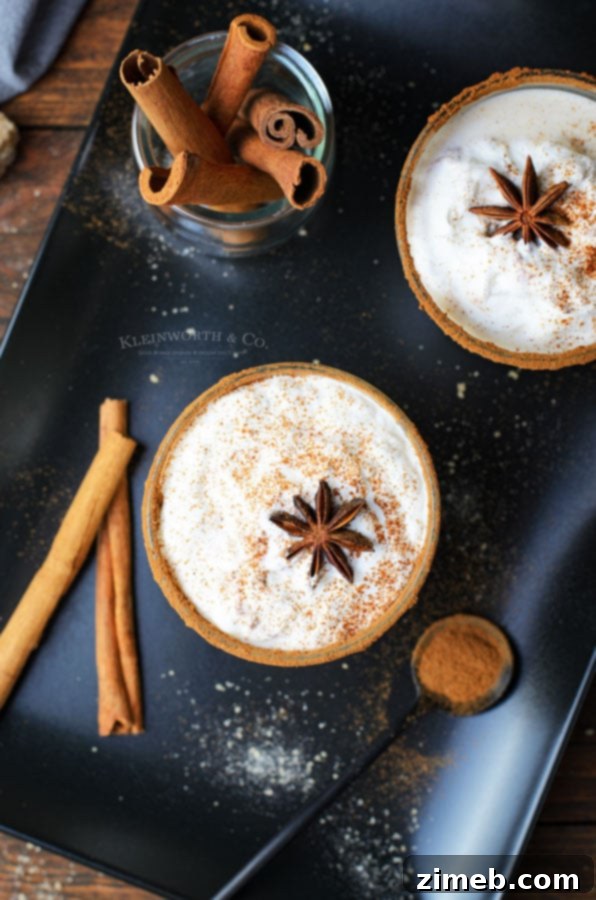 Timeless Homemade Eggnog 10 A glass of creamy eggnog garnished with fresh whipped cream and a sprinkle of spices, featuring the rich color of brandy as an optional addition.