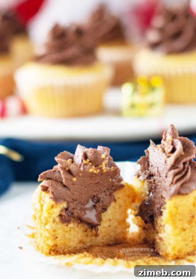 Close-up of the delicious Nutella filling inside a vanilla cupcake.