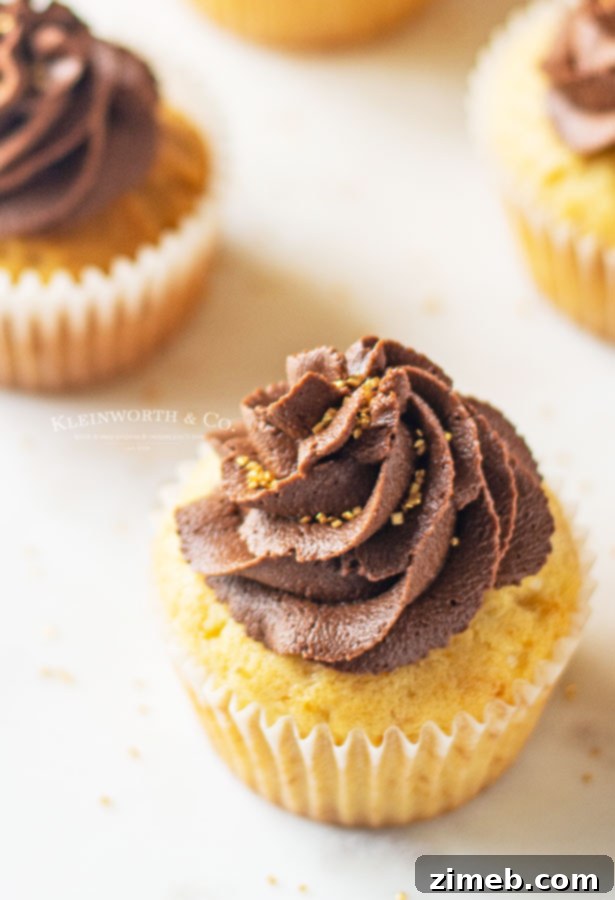 Freshly baked vanilla cupcakes, ready for Nutella filling and chocolate frosting.