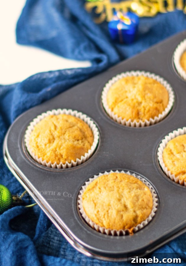 Baked vanilla cupcakes cooling, waiting to be filled with Nutella.