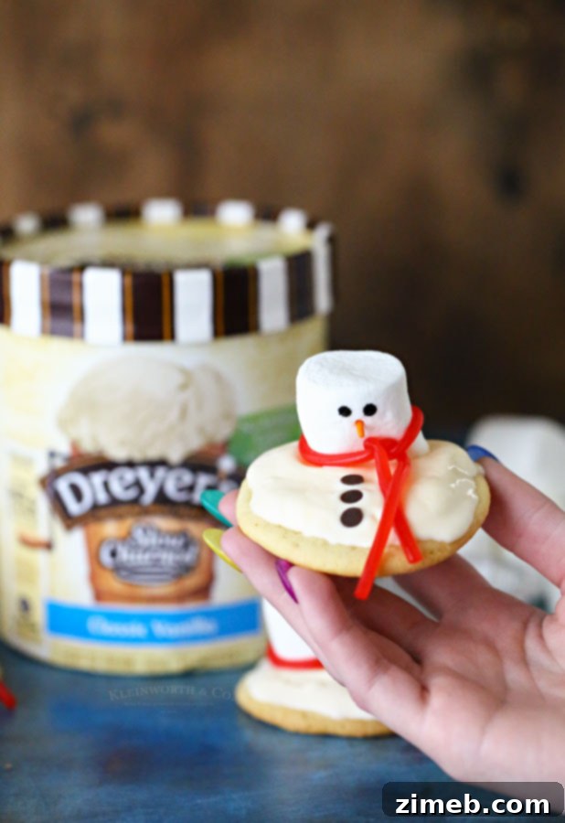 Frosted Snowman Meltdown Cookies 2 Melting Snowman Ice Cream Cookies, a delightful winter dessert perfect for holiday gatherings and family fun. Features sugar cookies, vanilla ice cream, and festive marshmallow snowman decorations.