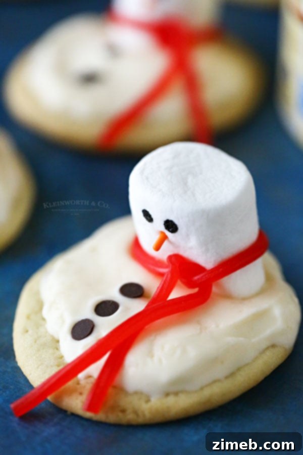 Frosted Snowman Meltdown Cookies 9 How to make Melting Snowman Frosted Cookies, demonstrating the step-by-step process of assembling this festive dessert with ice cream and marshmallow decorations.