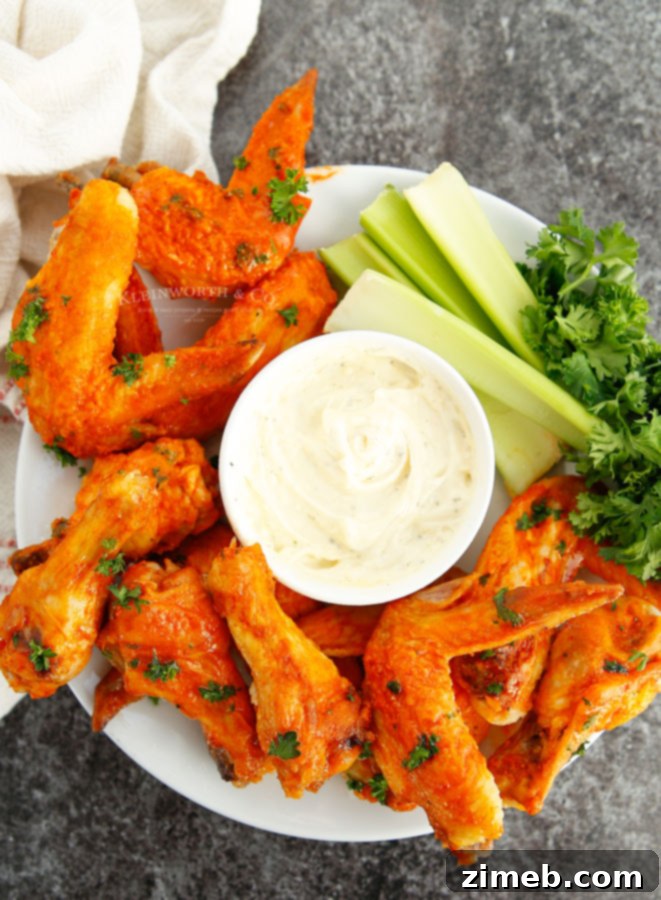 Ultimate Buffalo Wings 5 Air fried chicken wings tossed in buffalo sauce, garnished with parsley.