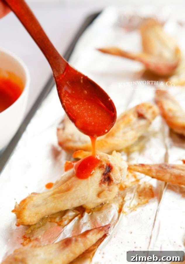 Ultimate Buffalo Wings 8 Baked chicken wings in buffalo sauce, garnished with fresh herbs.