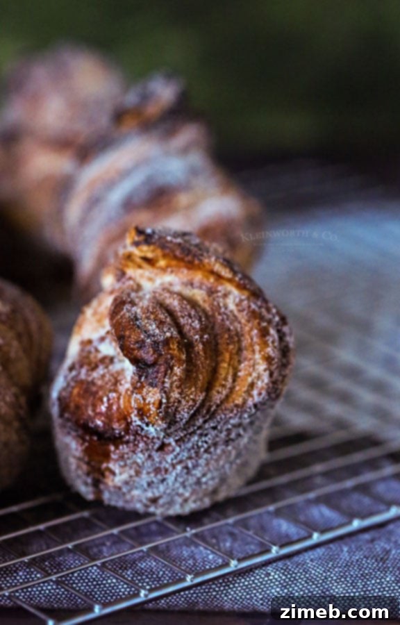 Effortless Homemade Cruffins 3 Cruffin Recipe showing crispy layers and cinnamon sugar coating.