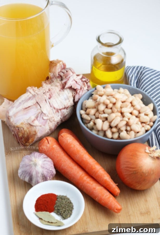 Ingredients for making Ham and Bean Soup, featuring ham bone and white beans