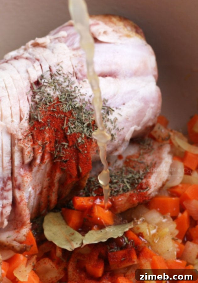 Adding broth to Ham and Bean Soup in a Dutch oven
