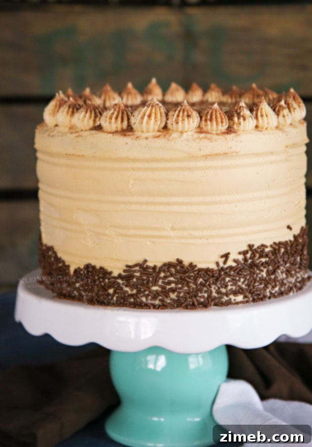Rich Coffee Buttercream Frosting 5 A slice of coffee-flavored birthday cake adorned with elegant espresso buttercream frosting, sitting on a cake stand.