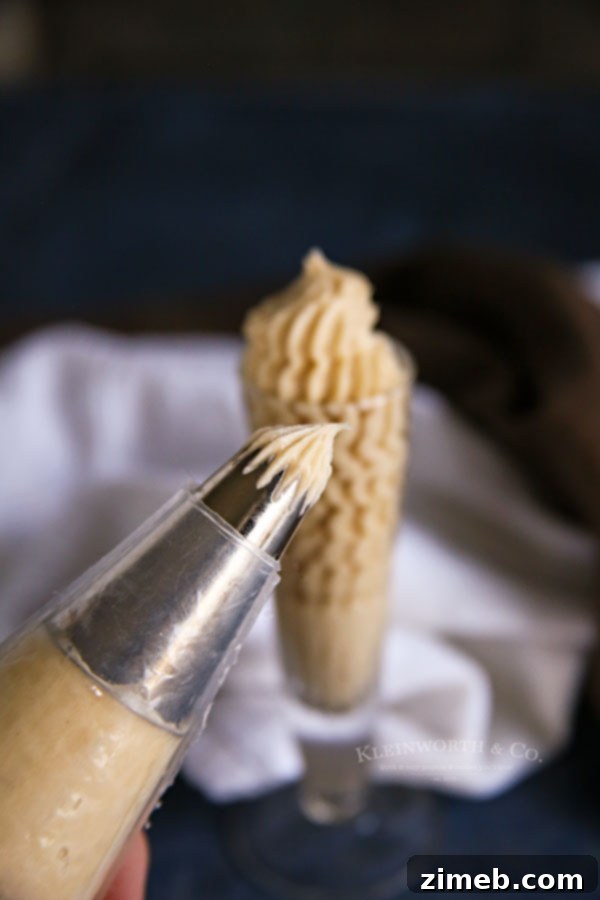 Rich Coffee Buttercream Frosting 7 Coffee frosting loaded into a piping bag, ready for intricate cake decoration.