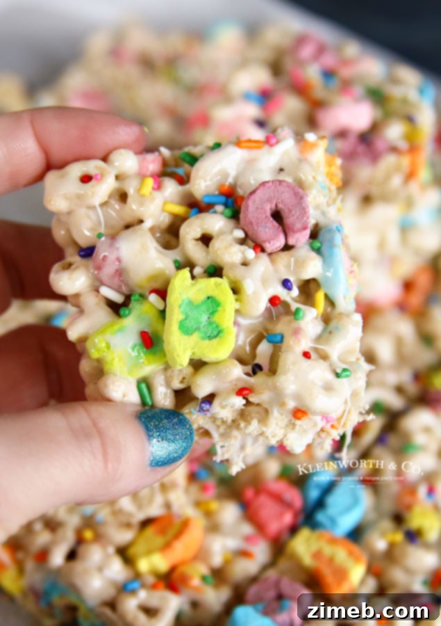 Charmed Confections 3 Close-up of green and white St. Patrick's Day Rice Krispie treats, adorned with colorful sprinkles.
