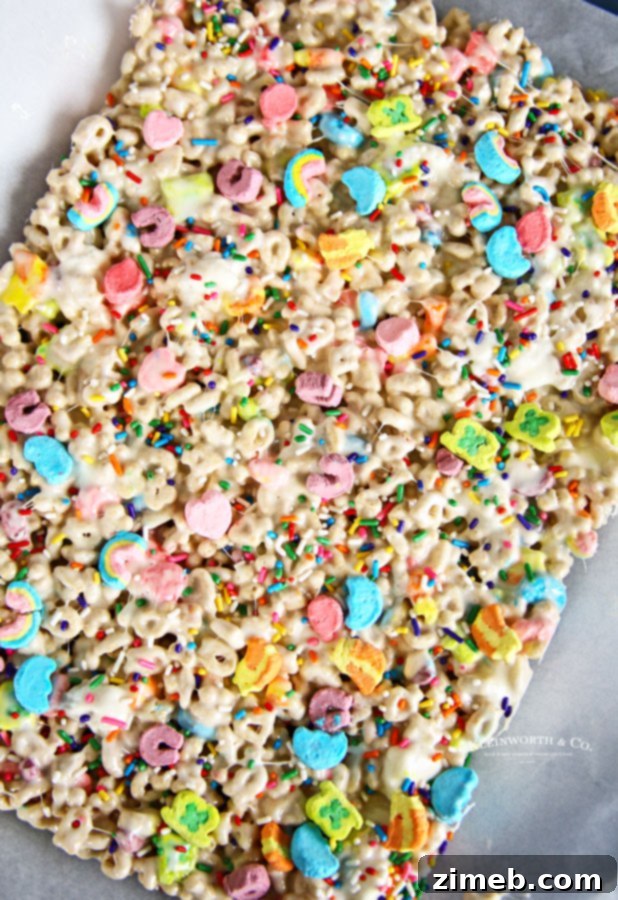 Charmed Confections 5 Freshly made Lucky Charms Rice Krispies treats in a pan, ready to be cut.