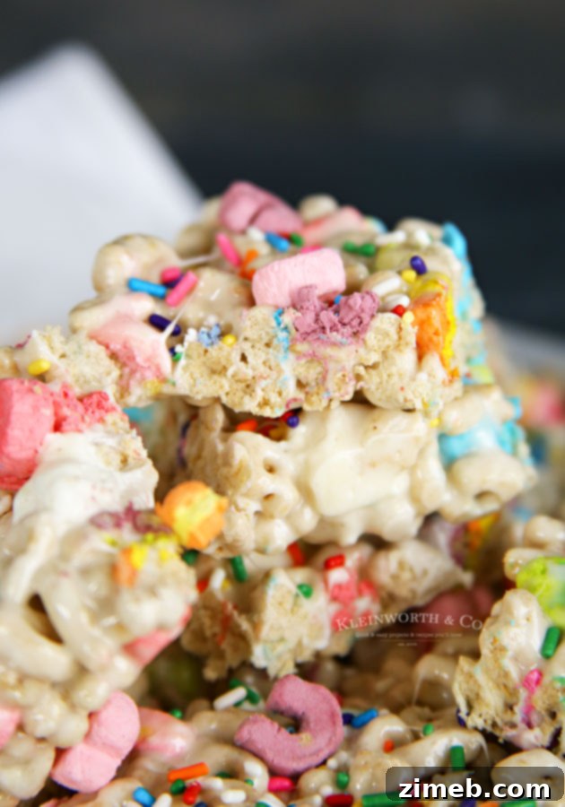 Charmed Confections 6 A tray of festive St. Patrick's Day treats, featuring Lucky Charms cereal bars with colorful marshmallows.