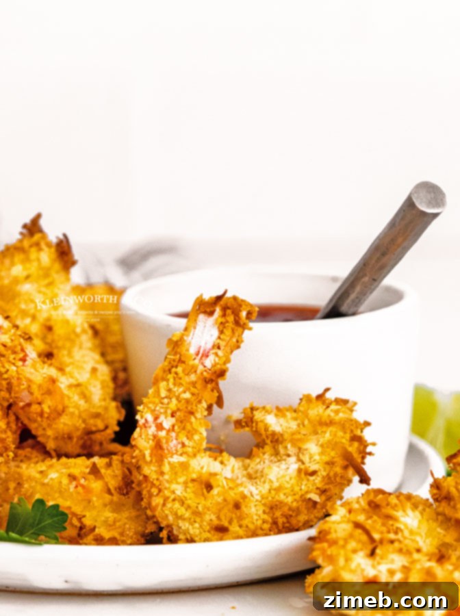 Crispy Air-Fried Coconut Shrimp 3 Close-up of golden brown air-fried shrimp with coconut flakes, ready to be served.
