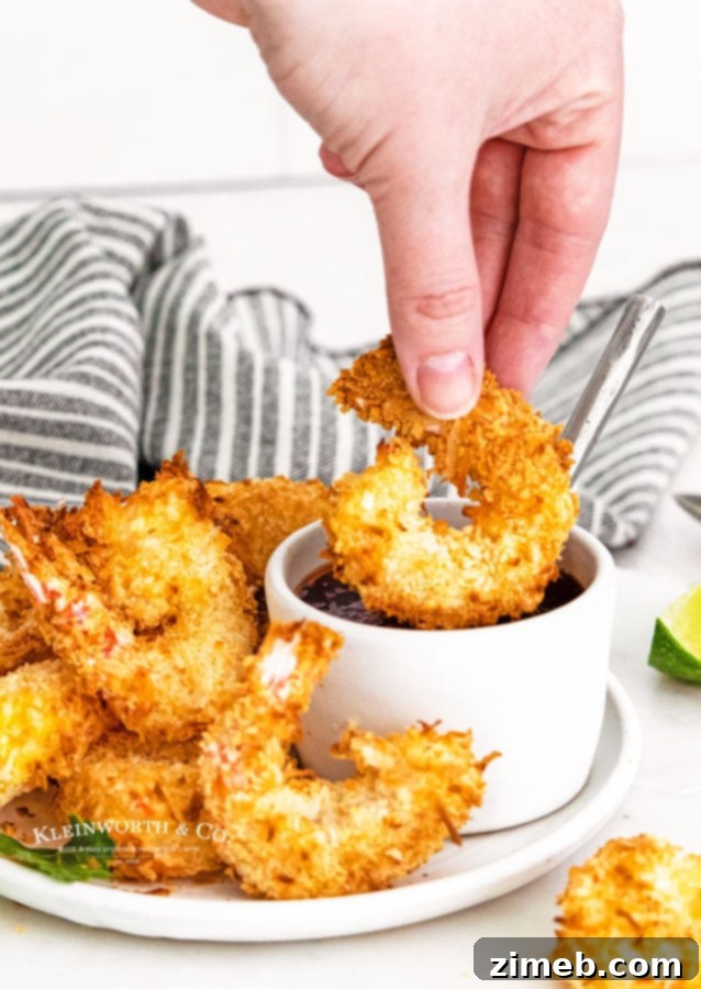 Crispy Air-Fried Coconut Shrimp 4 Platter of freshly air-fried coconut shrimp with a dipping sauce, highlighting the golden coating.