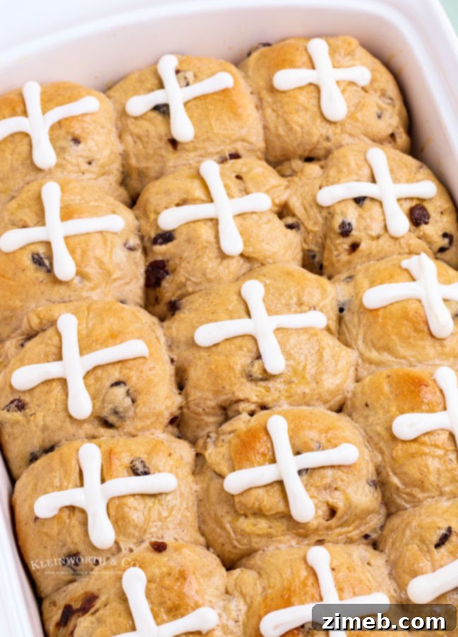 Freshly baked cross rolls with delicate icing crosses, a sweet and traditional Easter treat.