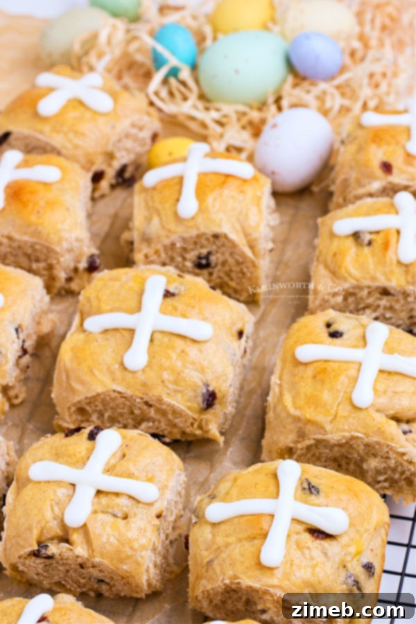 A tray of beautifully risen cross rolls, ready for the oven, promising a delightful Easter treat.