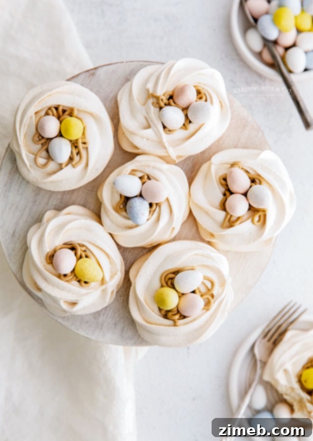 Holiday Meringue Nests decorated with mini eggs and frosting