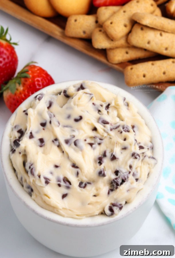 A close-up of a bowl of edible cookie dough dip, showcasing its rich, creamy texture and visible chocolate chips. This quick and easy no-bake dessert is perfect for parties and dipping, offering a safe, egg-free indulgence ready in 5 minutes.