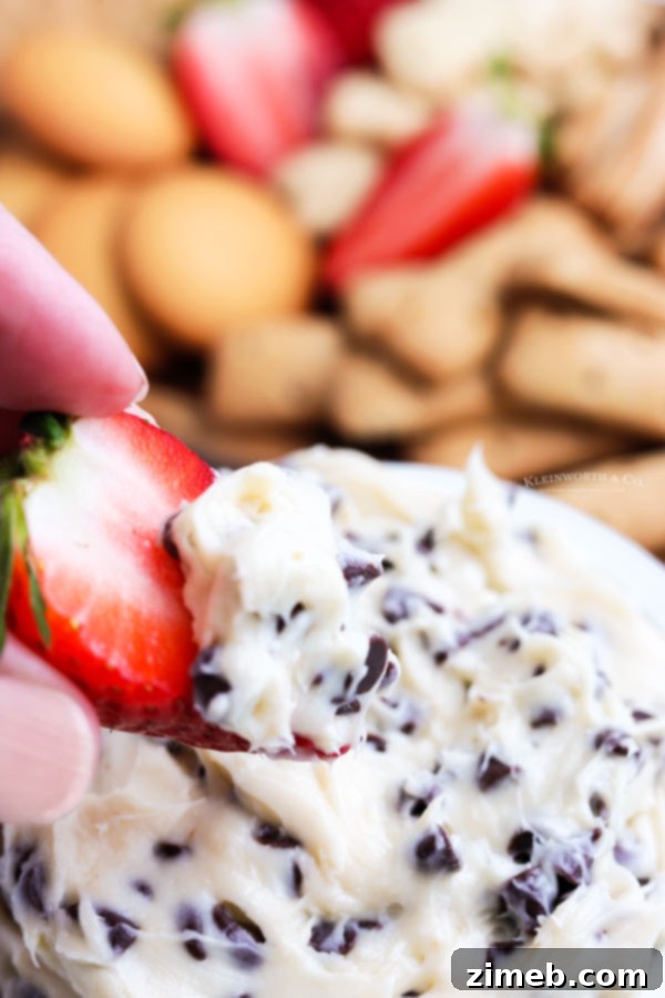 A vibrant dessert dip with fresh strawberries, showcasing the versatility of Cookie Dough Dip. This quick and easy no-bake dessert is perfect for dipping, ideal for parties, and offers an egg-free, sweet indulgence ready in 5 minutes.