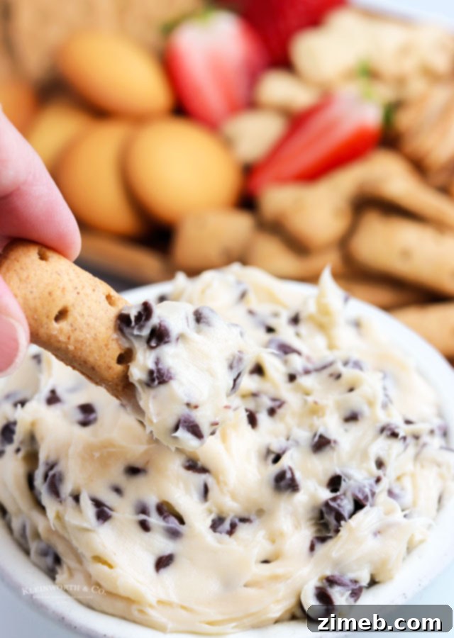 A smooth and creamy cream cheese dip, featuring the delicious flavors of cookie dough. This quick and easy chocolate chip dessert dip is perfect for any gathering and can be served with a variety of dippers. An egg-free, no-bake delight ready in 5 minutes.