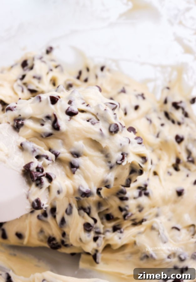 A close-up of the delicious dessert recipe, Cookie Dough Dip, presented beautifully. This quick and easy no-bake dip is perfect for parties and ideal for dipping with cookies, fresh fruit, or pretzels. An egg-free treat ready in just 5 minutes.