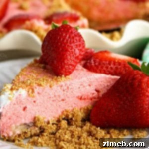Banana Split Bliss Cake 13 A slice of no-bake strawberry banana cheesecake on a plate. The dessert looks light and refreshing, perfect for a summer treat.