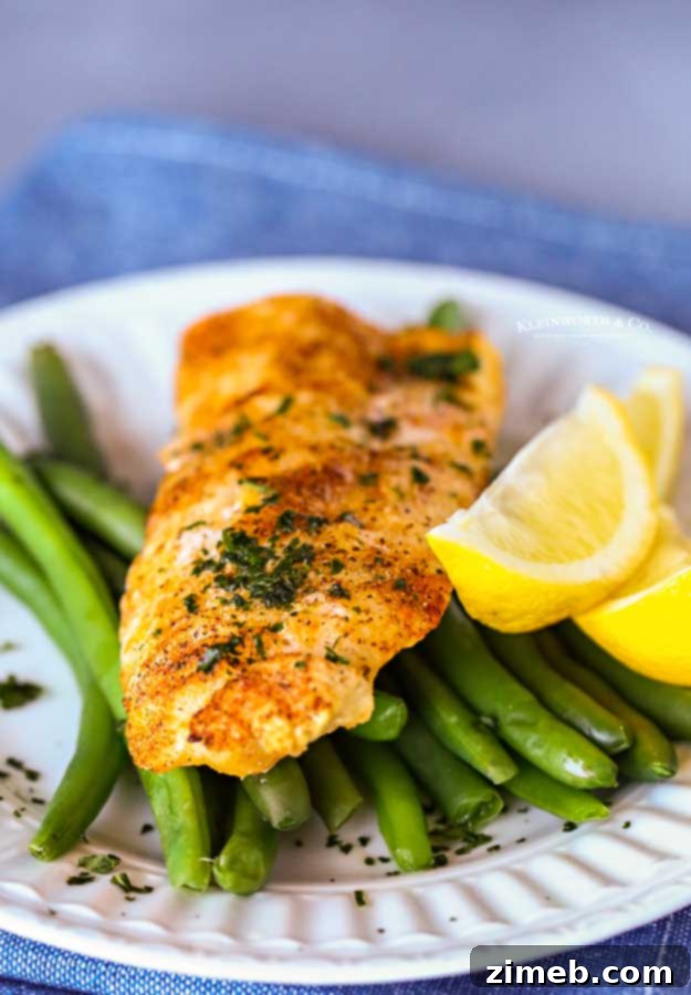 Air fried cod fillet served with vibrant green beans, seasoned perfectly.