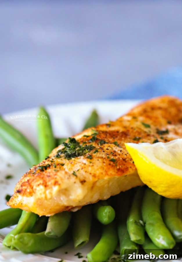 Healthy cod dinner prepared in an air fryer, featuring perfectly flaky fish.