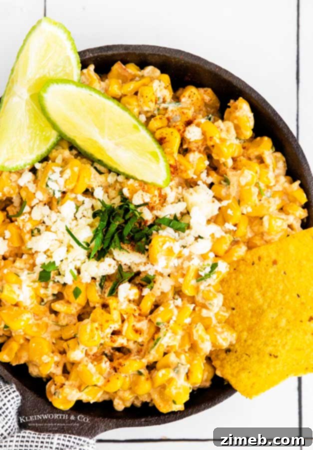 street corn dip in a serving bowl with tortilla chips