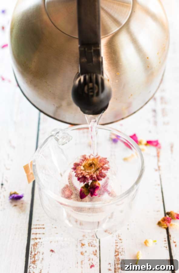 Craft Your Own Tea Bombs 10 Hot water being poured over a tea bomb, creating a floral tea infusion