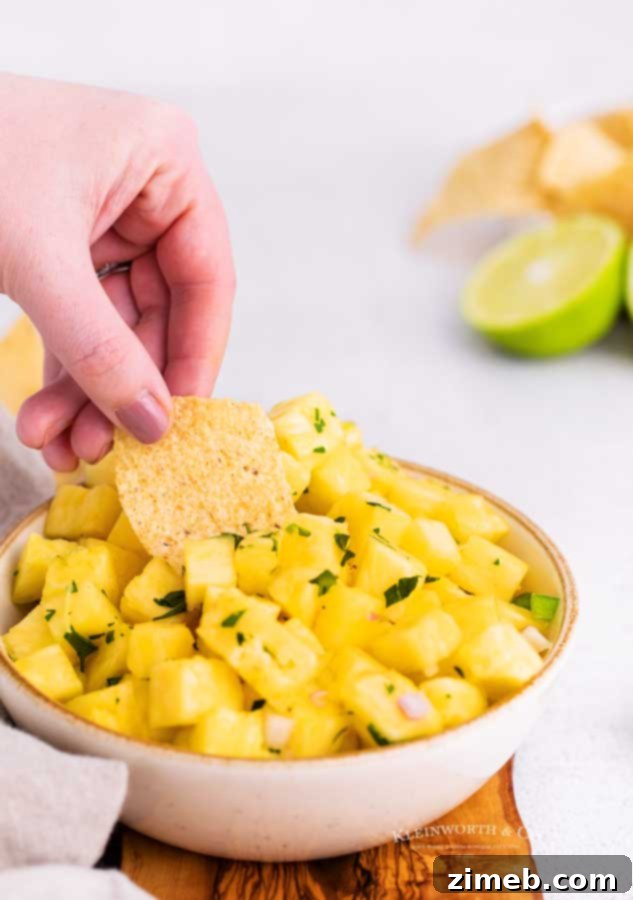 Tropical Pineapple Salsa 17 Bowl of sweet and spicy fruit salsa surrounded by colorful tortilla chips