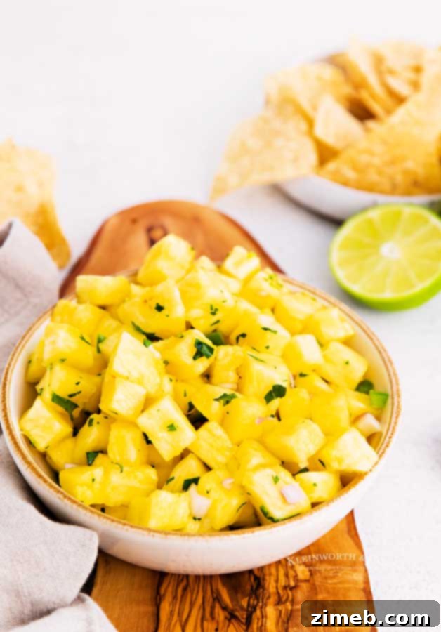 Tropical Pineapple Salsa 3 Close-up of a bowl of homemade fruit salsa, featuring golden pineapple chunks