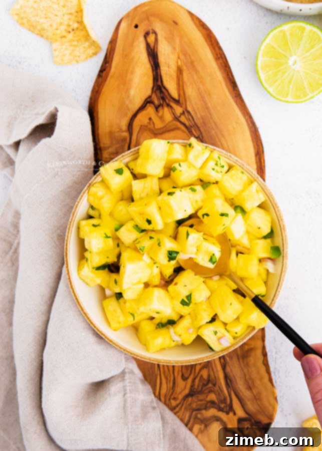 Tropical Pineapple Salsa 4 Sweet and Spicy Pineapple Mango Salsa in a serving bowl with tortilla chips