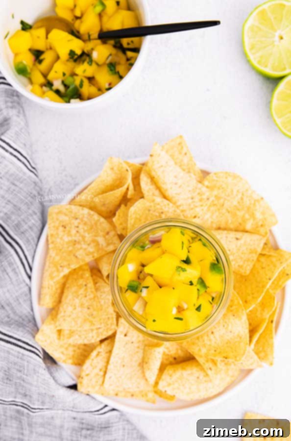Tropical Pineapple Salsa 9 Refreshing pineapple and mango salsa displayed with colorful tortilla chips, perfect for a party