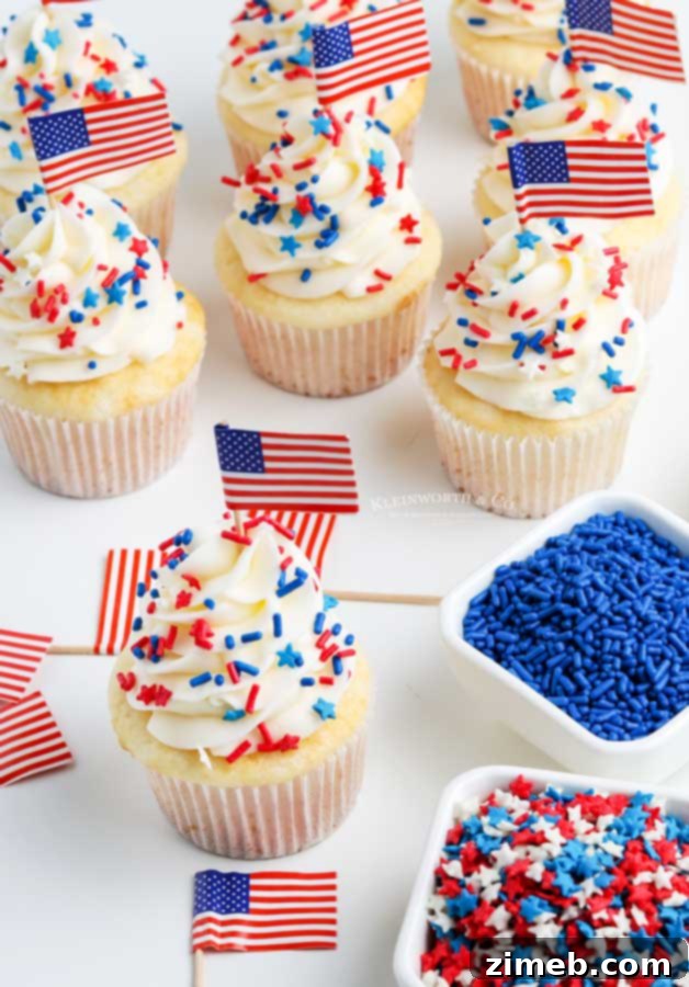 Adorable cupcakes adorned with mini American flags, perfect for patriotic celebrations and 4th of July festivities.