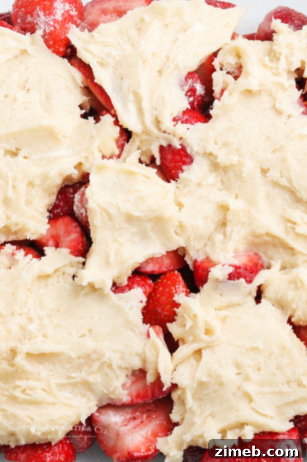 Unbaked strawberry cobbler in a dish, ready for the oven.