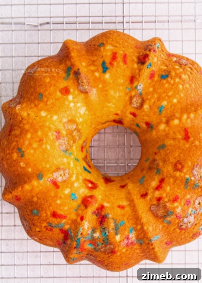 A freshly baked, golden brown bundt cake, still in the pan, highlighting its beautiful fluted design before frosting.