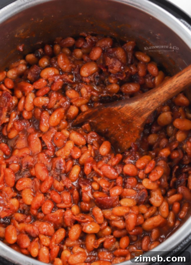 Ultimate Instant Pot Baked Beans 15 Cooking baked beans in the Instant Pot, showing the ingredients simmering.