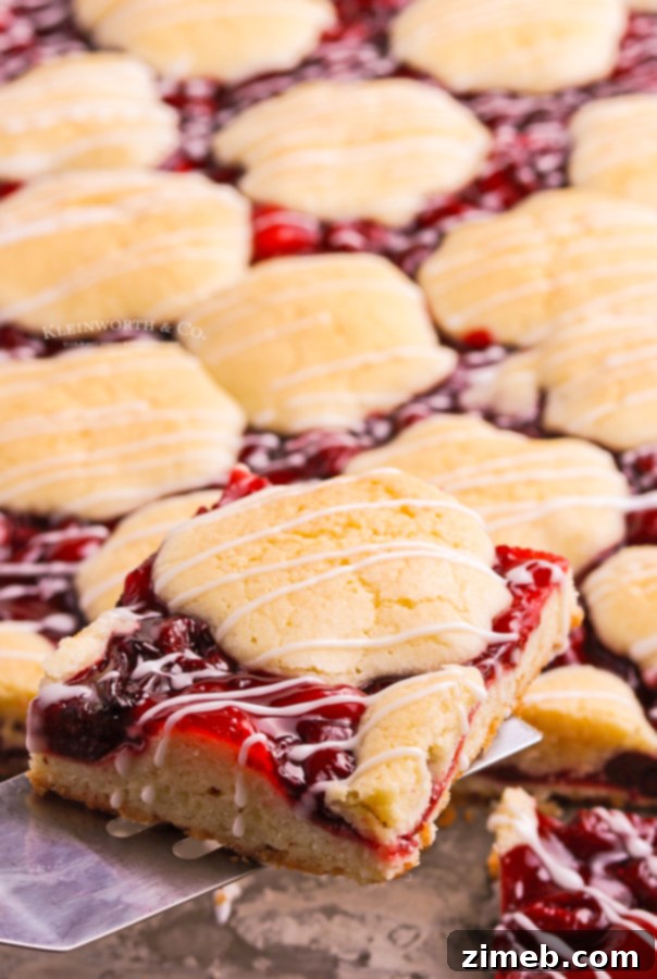 Ruby Red Cherry Squares 3 Close-up of delicious cherry squares, showing the crumble topping and juicy fruit filling, ready to be served.