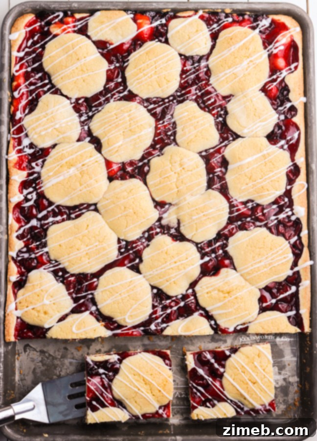 Ruby Red Cherry Squares 5 Sheet pan cherry bars fresh out of the oven, topped with a beautiful white glaze, a perfect dessert for sharing.