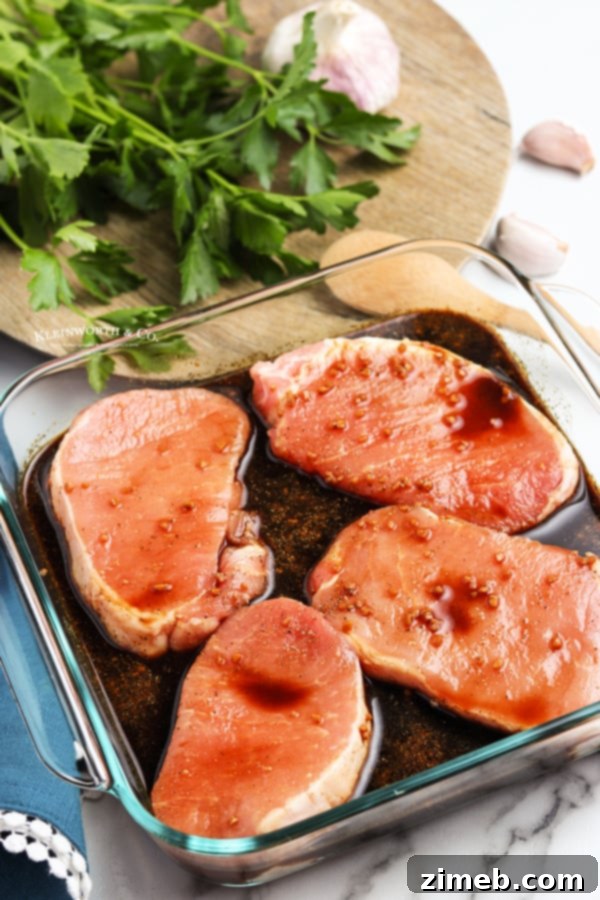 Pork chops being marinated for grilling